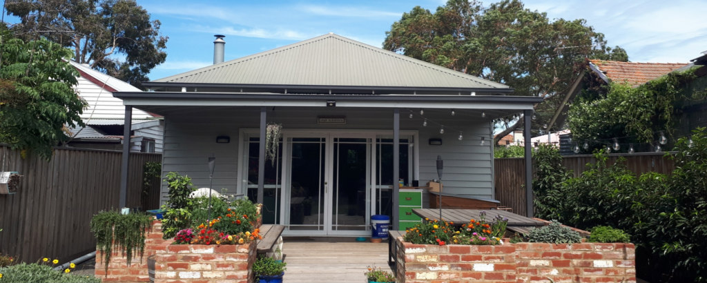 Free standing weatherboard home with brick fence